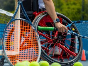 Wheelchair tennis player on court, highlighting how NDIS planning supports participation in sports and daily living activities.