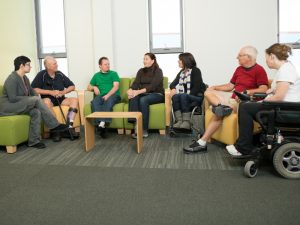 Group of people with disabilities in a discussion circle, emphasizing the collaborative process of NDIS planning for support.