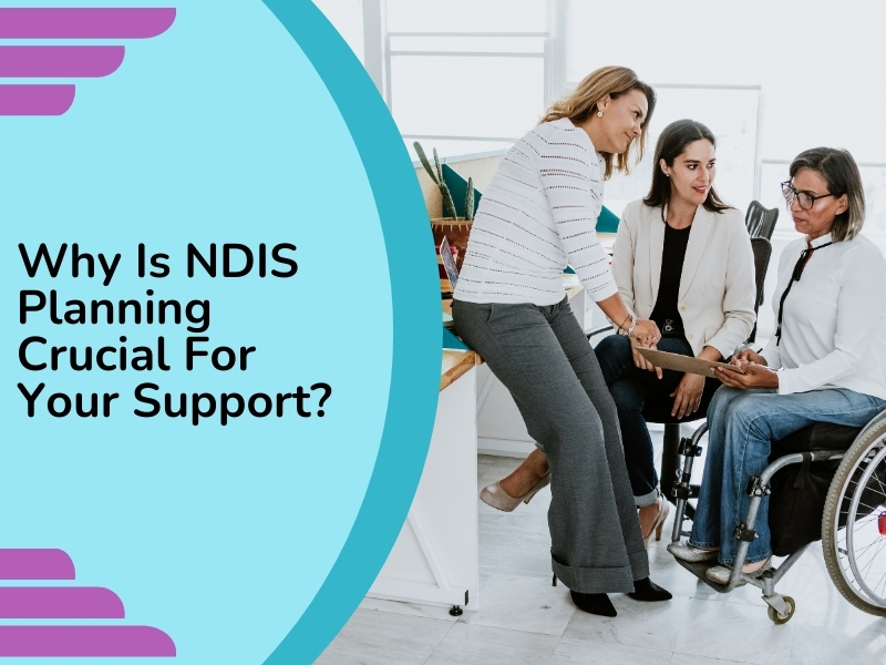 Three women, one in a wheelchair, discussing documents in an office, highlighting the importance of NDIS planning support.