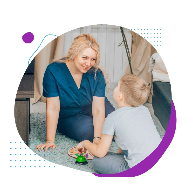 A child engages with a caregiver in a warm, supportive setting, demonstrating interactive learning—perfect for Cognitive Behavioural Therapy Courses.