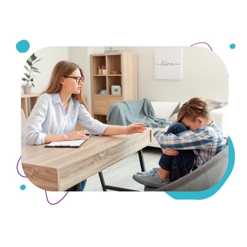 A Cognitive Behaviour Therapy Sydney session where a therapist gently speaks to a child sitting on a couch in a warm, light-filled room.